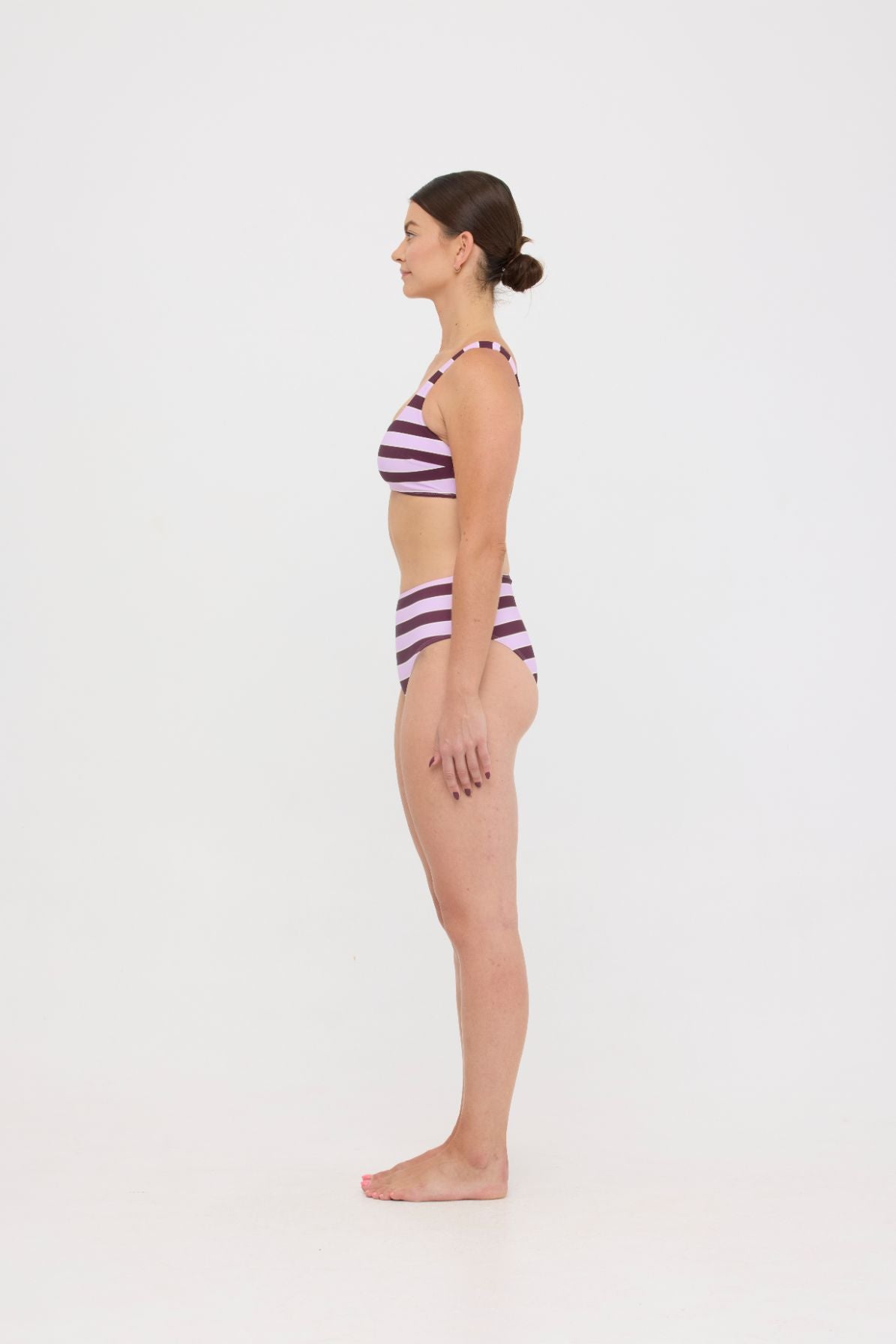 Model in Violet and Plum mixed-stripe HUZZAH Chilli crop bikini top paired with mid-waisted full-coverage bottoms