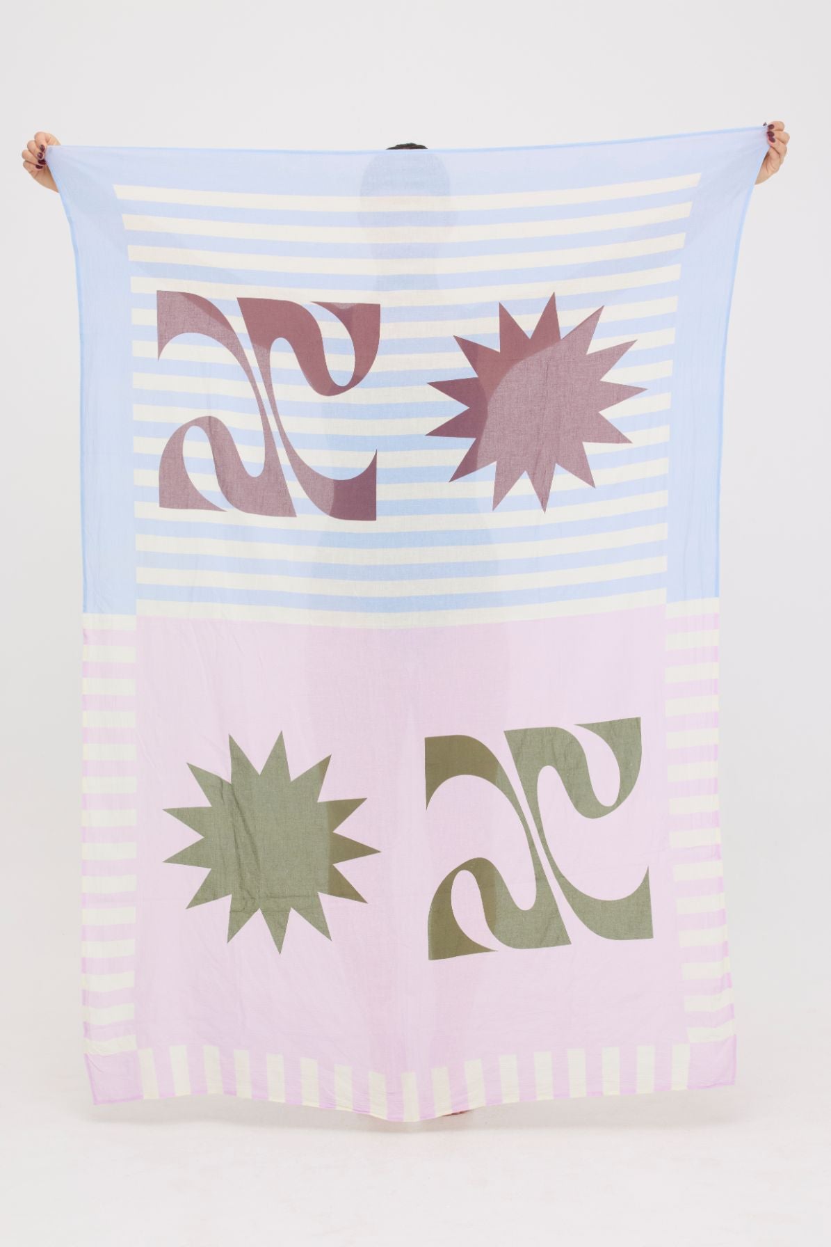 Colourful abstract lightweight HUZZAH Sarong held up by a woman 