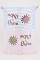 Colourful abstract lightweight HUZZAH Sarong held up by a woman 