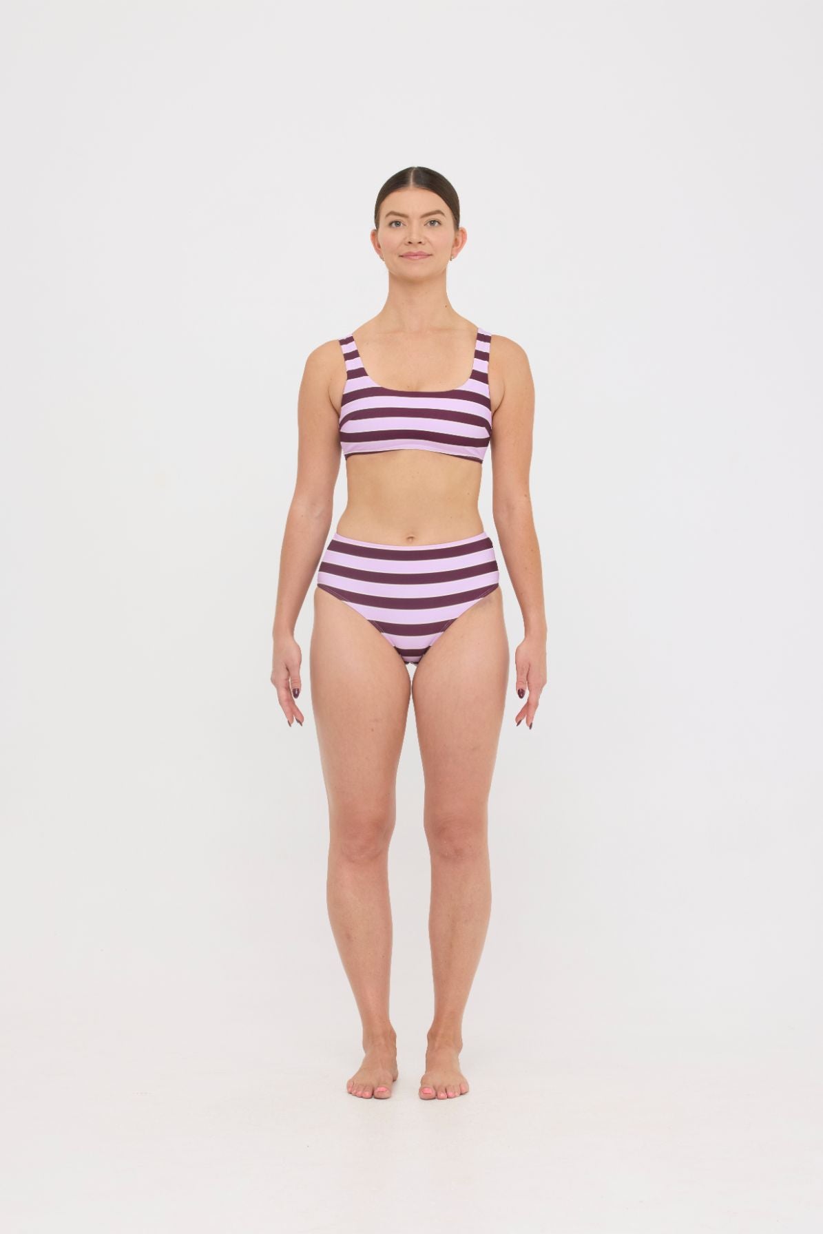Model in Violet and Plum mixed-stripe HUZZAH Chilli crop bikini top paired with mid-waisted full-coverage bottoms
