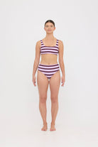 Model in Violet and Plum mixed-stripe HUZZAH Chilli crop bikini top paired with mid-waisted full-coverage bottoms