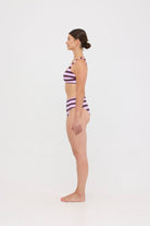 Model in Violet and Plum mixed-stripe HUZZAH Chilli crop bikini top paired with mid-waisted full-coverage bottoms