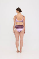 Model in Violet and Plum mixed-stripe HUZZAH Chilli crop bikini top paired with mid-waisted full-coverage bottoms