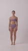 Model in Violet and Plum mixed-stripe HUZZAH Chilli crop bikini top paired with mid-waisted full-coverage bottoms
