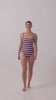 Model wearing the violet and plum mixed stripe HUZZAH Cat one-piece swimsuit with sculpting fit and clean lines, photographed against a plain background